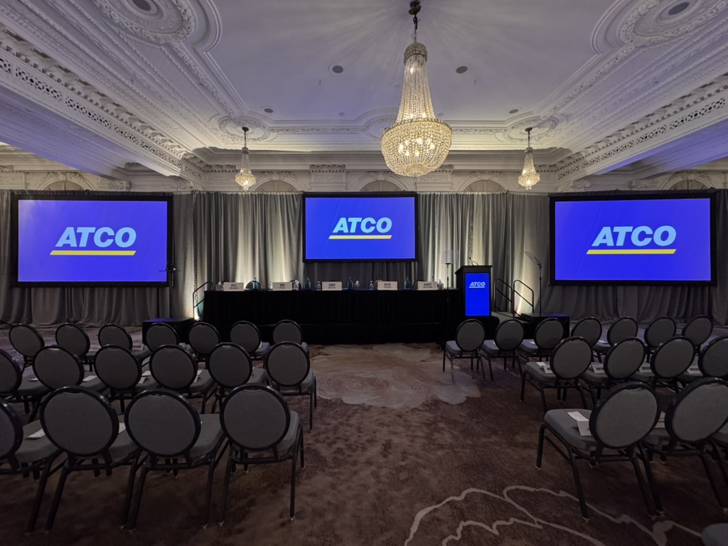 ATCO annual general meeting stage with three screens and lectern